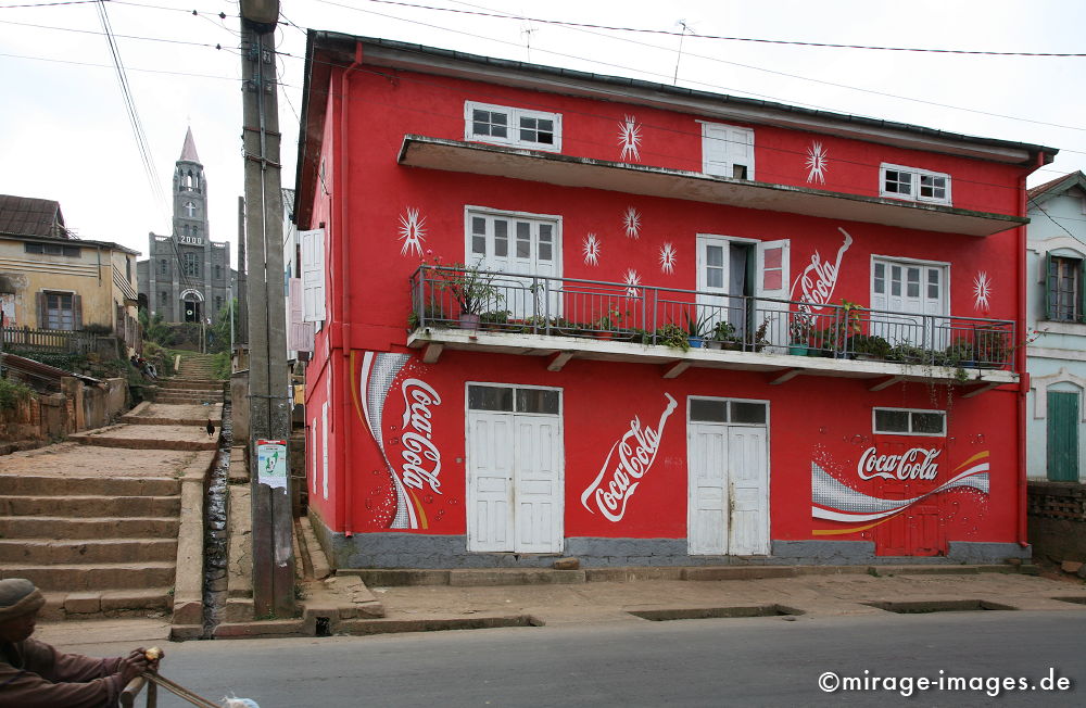 Coke and Religion
Ambatolampy
Schlüsselwörter: Christentum, Dorf, Einmischung, Erfrischung, Fassade, Fassadenmalerei, Gegensatz, Gegensatz, Gegensätze, Getränk, global, Globalisierung, Idylle, idyllisch, Kapitalismus, katholisch, Katholizismus, Kommerz, Konsum, Kontrast, kontrastreich, Logo, modern,
